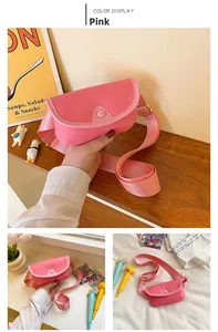 Detailed view of pink semi-circle kids crossbody bag with lychee texture and strap