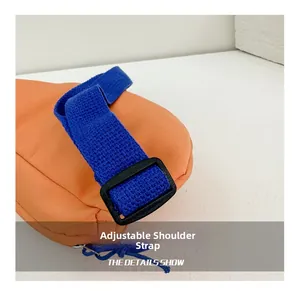 Detail of adjustable blue woven strap on vibrant orange canvas kids waist bag