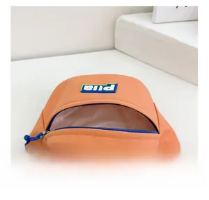 Detail view of orange canvas waist bag showing inner compartment and blue zipper