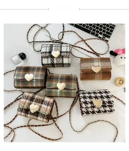 Collection of mini tweed crossbody bags with golden heart clasps and chain straps