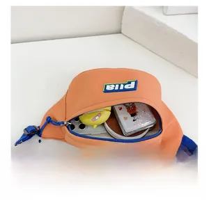 Detail view of the orange nylon chest bag internal storage for mobile phone and small purse