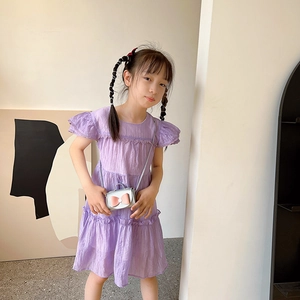 Girl's purple ruffle dress paired with a silver mini bow crossbody bag for kids