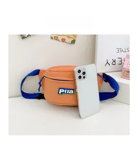 Mini orange canvas kids waist bag size comparison with a white smartphone for scale