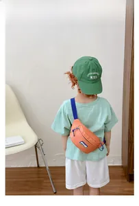 Close-up of stylish orange canvas kid waist bag with adjustable navy blue nylon strap