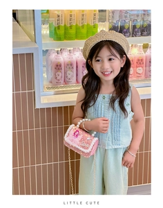 Pink sequin mini bag for girls with pearl handle and mermaid patch shown on a child model