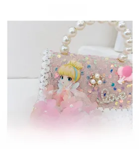 Close-up of pink sequin handbag featuring pearl handle, lace trim, and 3D floral details