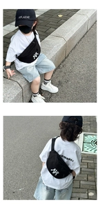 Detail view of the NY embroidery on a black canvas waist bag for kids with adjustable strap