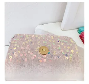 Detail of pink sequin fabric and golden magnetic ring closure on girls handbag
