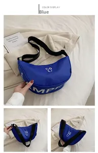 Detailed view of the blue canvas half-moon crossbody bag with wide adjustable strap