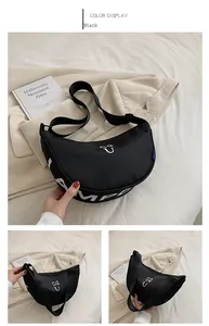 Detail of black nylon crescent shoulder bag with white graphic logo and wide strap