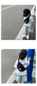 Close-up of kids black canvas waist bag with NY embroidery and adjustable strap