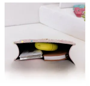 Internal view of pink sequin mini crossbody bag showing storage for small daily items