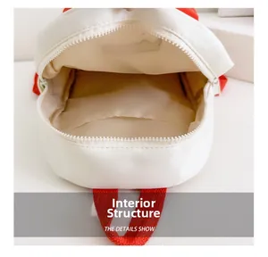 Internal view of a canvas backpack showing a yellow lining and spacious main compartment