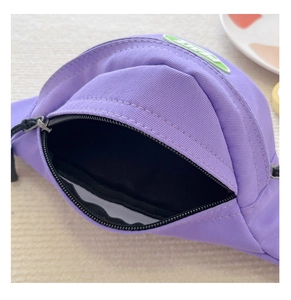 Detailed macro view of purple canvas waist bag showing zipper opening and black inner lining