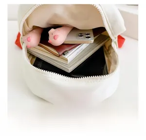 Internal view of canvas kids backpack showing storage for laptop and cute stationery