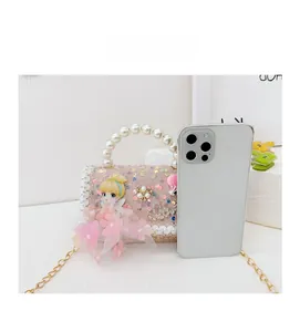 Size comparison of a mini pink sequined girl's handbag next to a smartphone