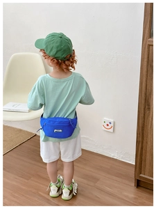 Blue canvas waist bag for kids featuring a zipper closure and adjustable strap