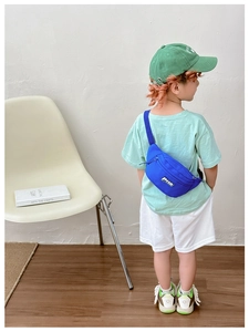 Close-up of bright blue kids nylon waist bag with adjustable strap and brand logo