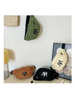 Detail view of canvas waist bags in four colors with embroidered letter logo and strap