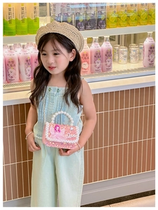 Pink sequin girls crossbody bag with pearl handle and fairy pattern shown on model