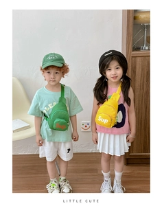 Detailed view of yellow and green canvas cross-body chest bags worn by young children