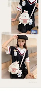 Detail of cute rabbit canvas crossbody bag with pink pocket and plush bunny pendant