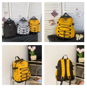 Detail view of durable nylon drawstring backpacks in black, grey, and ginger yellow colors