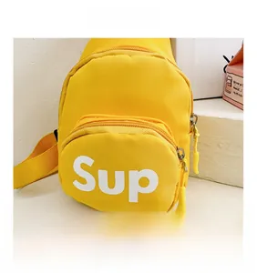 Detail of yellow nylon kids chest bag with Sup logo and double zipper compartments