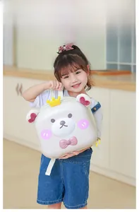 Detail view of cartoon bear hardshell toddler backpack with crown and bow on a young model