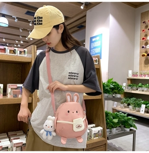 Pink cartoon rabbit crossbody bag with cute plush bunny charm and bunny ear details