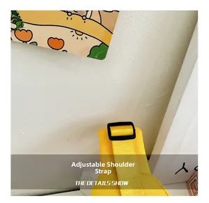 Detail of adjustable black strap with plastic buckle on a yellow canvas kids chest bag