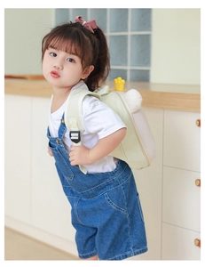 Detail of cute bear backpack with crown and ears for children in cream white