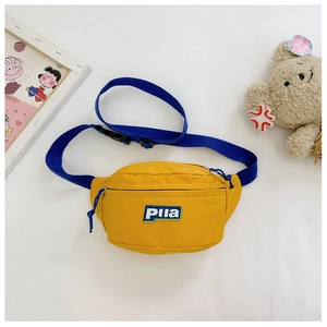 Detail of yellow canvas kids fanny pack with Piia logo and adjustable blue strap
