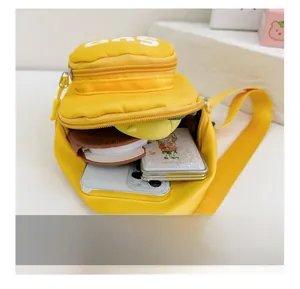 Internal view of yellow nylon kids chest bag showing storage capacity for daily items
