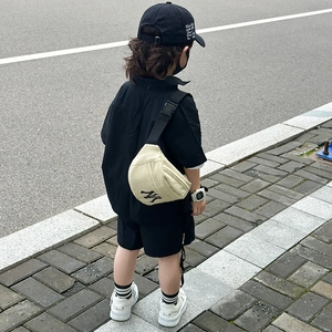 Kids canvas fanny pack in cream with black NY logo and adjustable strap for boys