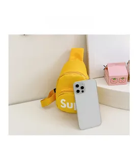 Mini yellow canvas kids bag shown next to a smartphone for size comparison scale