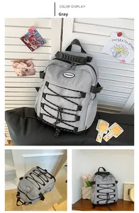 Detailed view of gray waterproof canvas backpack with elastic bungee and fashion logo