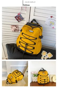 Detail view of large yellow canvas backpack showing durable fabric and front drawstring