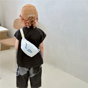 Kids minimalist white canvas waist bag with Piia logo worn by a young model outdoors