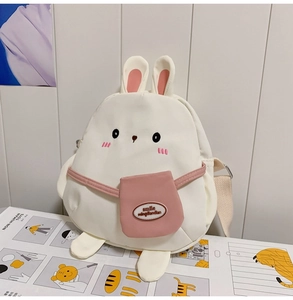 Close-up of white canvas bunny bag featuring pink ears and embroidered facial details