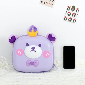 Close-up of a cute purple cartoon bear hardshell backpack with crown and bow details