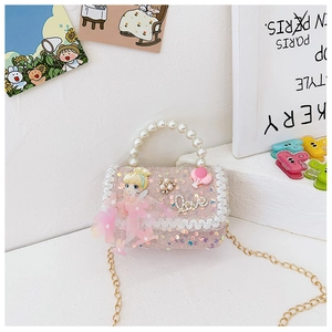 Detail of pink sequin girls' handbag with pearl handle, doll decor and lace trim