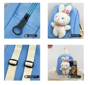Detail view of sky blue canvas mini backpack with plush rabbit and custom zipper pull