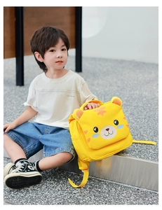 Outdoor shot of a toddler wearing a yellow tiger backpack with cute 3D ears and side pockets
