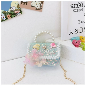 Detailed view of light blue sequined girl's handbag with pearl handle and lace trim