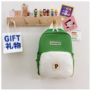Detail of color-block nylon toddler backpack with brand label and embroidery