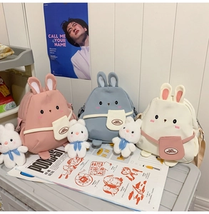Detailed view of three cute rabbit canvas shoulder bags in pink, blue, and white colors