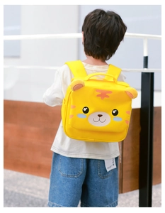 Rear view of a child wearing a cute yellow 3D tiger backpack with soft padded straps