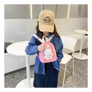 Detail of pink canvas kids backpack featuring a 3D plush bunny with plaid bow decoration