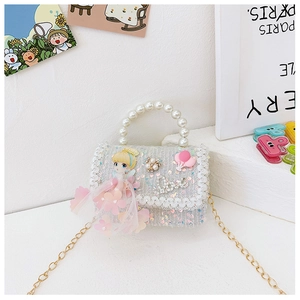Detail of blue sequin girls purse featuring a pearl handle and lace trim with a chain strap